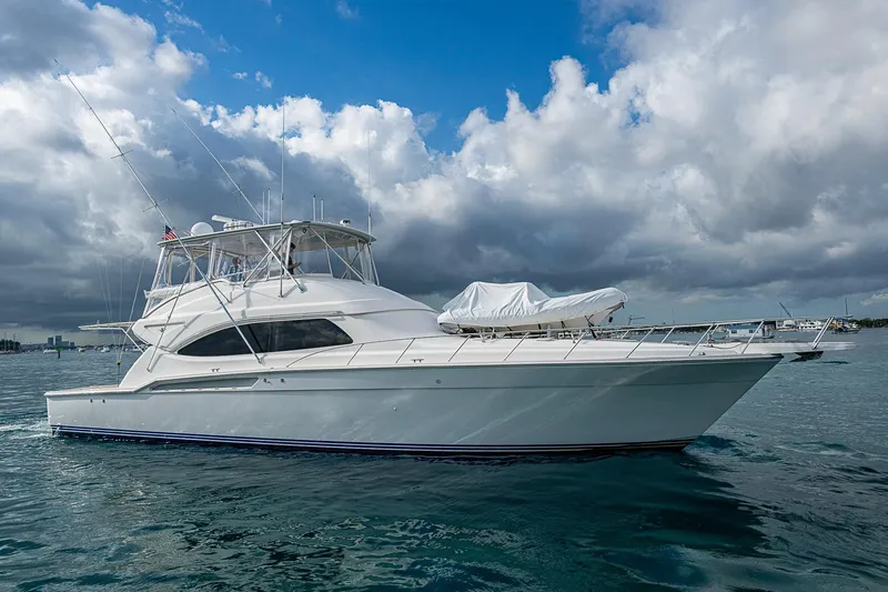 The Image of 2006 Bertram 630 Convertible yacht on water under cloudy sky. - 0