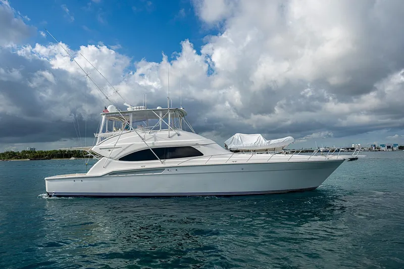 Slide: The Image of 2006 Bertram 630 Convertible yacht on open water under cloudy sky. - 10