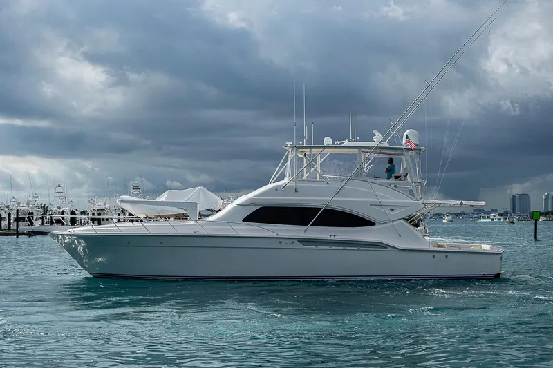 Slide: The Image of 2006 Bertram 630 Convertible yacht on water under cloudy sky. - 12