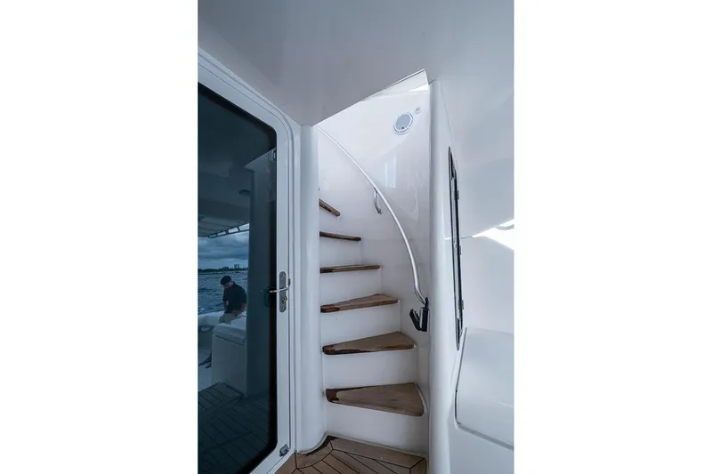 Slide: The Image of Staircase on 2006 Bertram 630 Convertible yacht with wooden steps and sleek design. - 19