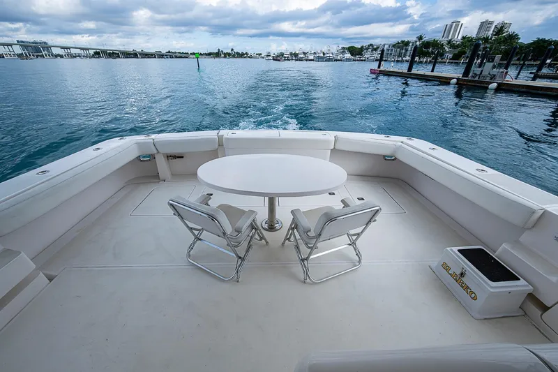 Slide: The Image of 2006 Bertram 630 Convertible yacht deck with table and chairs, overlooking marina. - 20