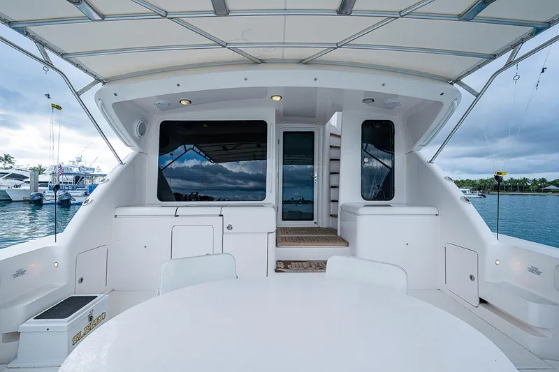 Slide: The Image of 2006 Bertram 630 Convertible yacht deck with marina view and overcast sky. - 21