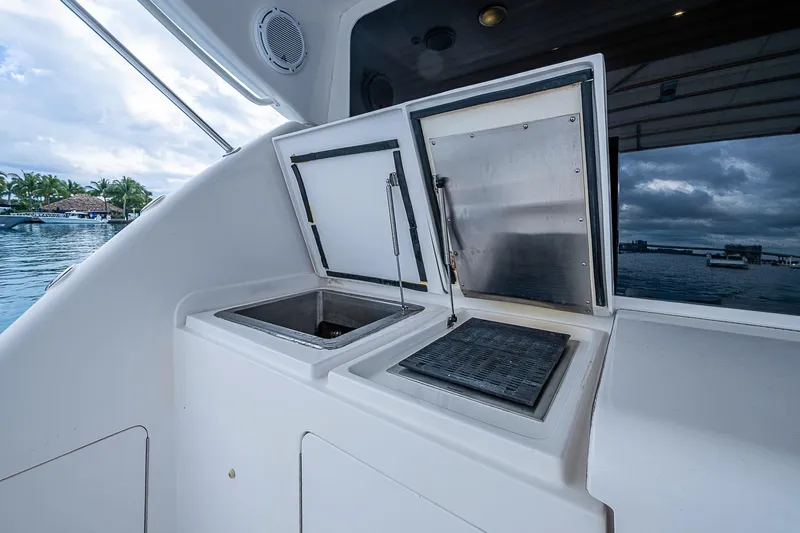 Slide: The Image of 2006 Bertram 630 Convertible yacht with open storage compartments, dockside view. - 24