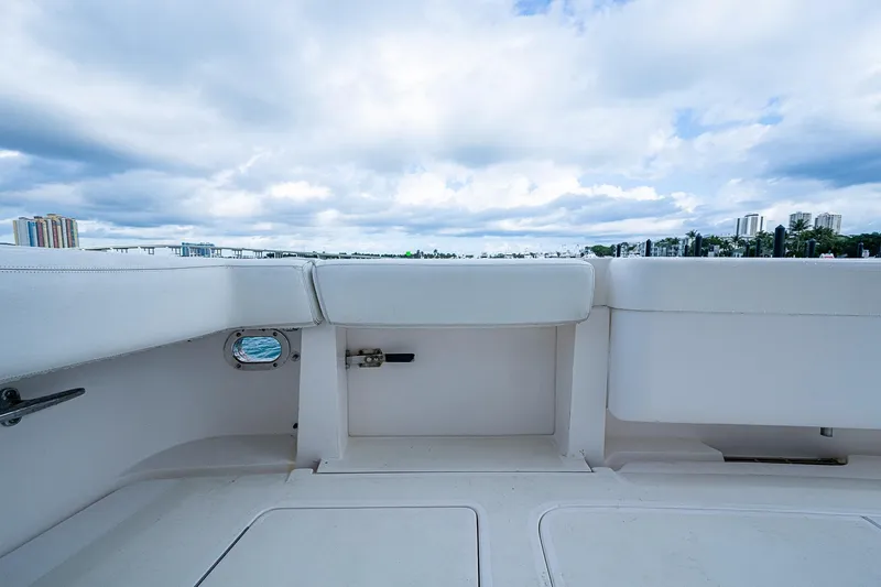 Slide: The Image of 2006 Bertram 630 Convertible yacht deck with city skyline and cloudy sky. - 25