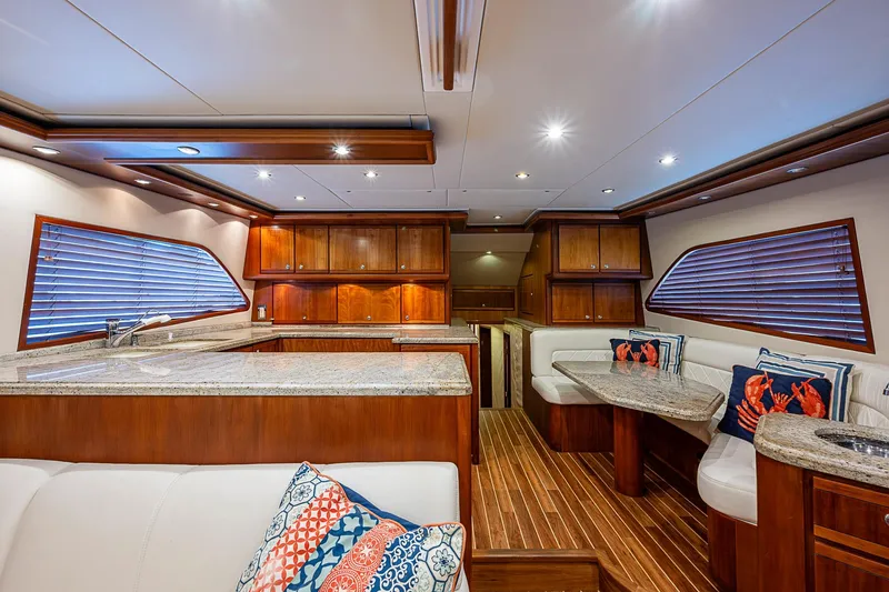 Slide: The Image of Luxurious interior of 2006 Bertram 630 Convertible yacht with wood finishes and plush seating. - 26
