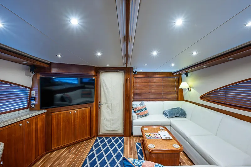 Slide: The Image of Luxurious interior of 2006 Bertram 630 Convertible yacht with elegant wood finishes and cozy seating. - 28