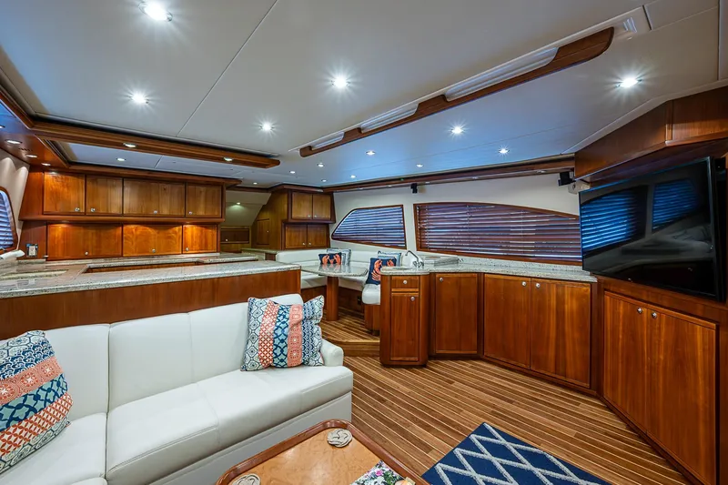Slide: The Image of Luxurious interior of a 2006 Bertram 630 Convertible yacht with elegant wood finishes. - 30