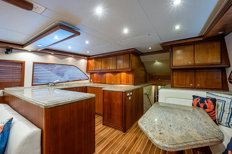 Slide: The Image of Luxurious interior of 2006 Bertram 630 Convertible yacht with wood cabinetry and granite countertops. - 31