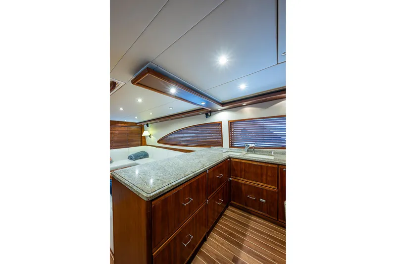 Slide: The Image of Luxurious interior of 2006 Bertram 630 Convertible yacht with wood cabinetry and granite countertops. - 33