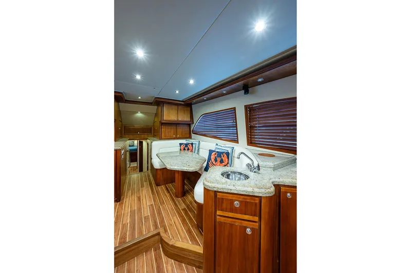 Slide: The Image of Luxurious interior of 2006 Bertram 630 Convertible yacht with wood finishes and modern amenities. - 34