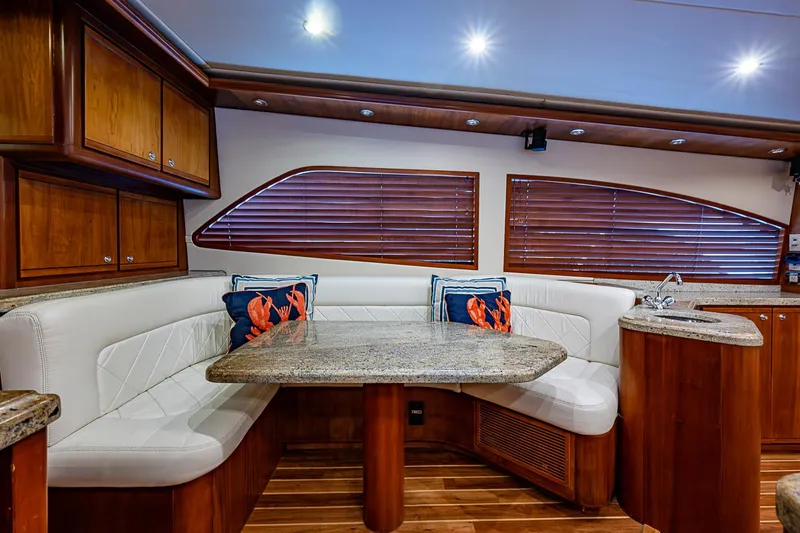 Slide: The Image of Luxurious 2006 Bertram 630 Convertible yacht interior with elegant seating and wooden accents. - 35