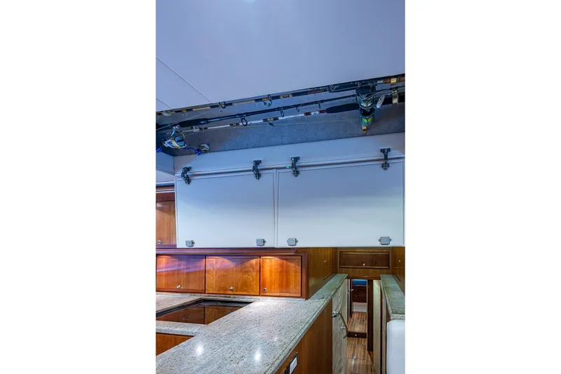 Slide: The Image of Interior of 2006 Bertram 630 Convertible yacht with granite countertops and wooden cabinetry. - 38