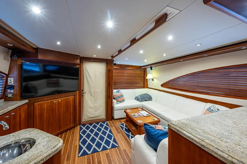 Slide: The Image of Luxurious interior of 2006 Bertram 630 Convertible yacht with elegant wood finishes and plush seating. - 39