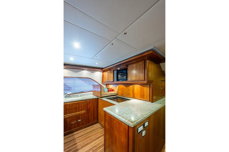 Slide: The Image of Luxurious kitchen interior of 2006 Bertram 630 Convertible yacht with wooden cabinetry. - 40