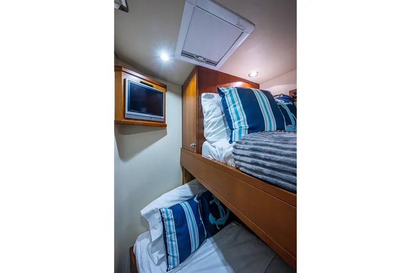 Slide: The Image of Cozy cabin interior of 2006 Bertram 630 Convertible with bunk beds and TV. - 44