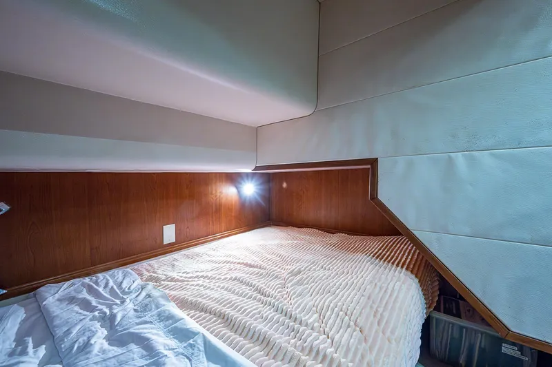 Slide: The Image of Cozy cabin interior of 2006 Bertram 630 Convertible yacht with soft lighting. - 47