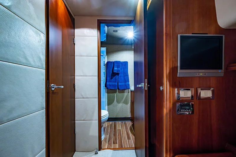 Slide: The Image of Interior of 2006 Bertram 630 Convertible yacht with wooden finishes and modern amenities. - 49