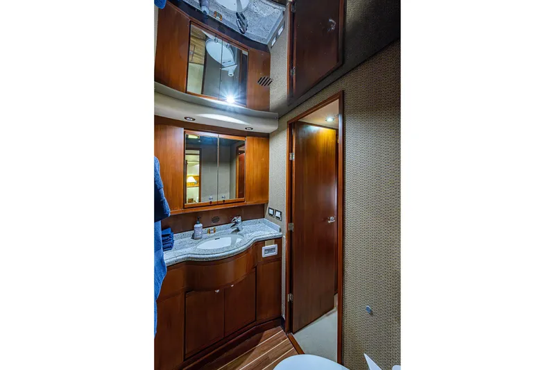 Slide: The Image of Luxurious bathroom interior of 2006 Bertram 630 Convertible yacht with wooden cabinetry. - 50
