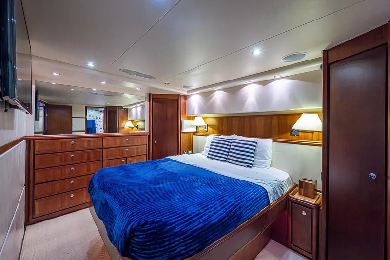 Slide: The Image of Luxurious bedroom interior of 2006 Bertram 630 Convertible yacht with elegant wood finishes. - 54