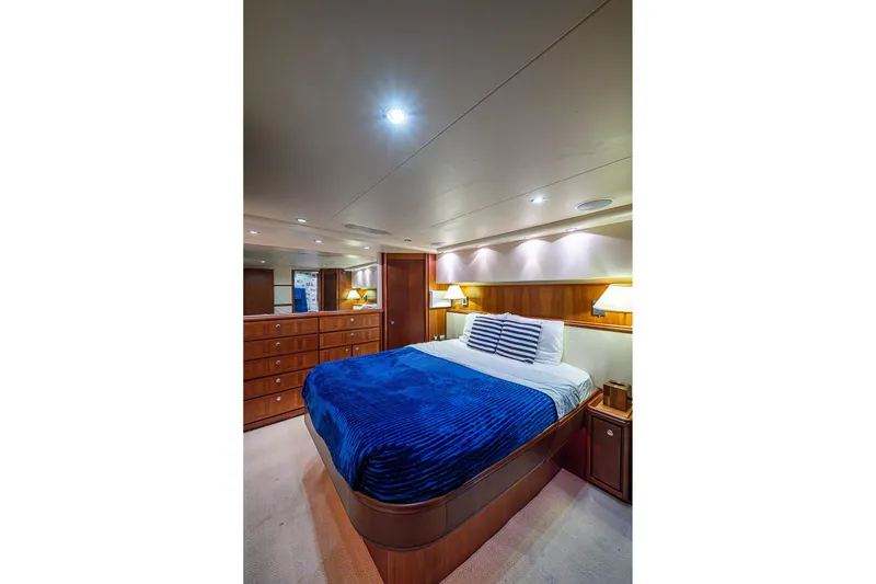Slide: The Image of Luxurious bedroom interior of 2006 Bertram 630 Convertible yacht with elegant wood finish. - 58