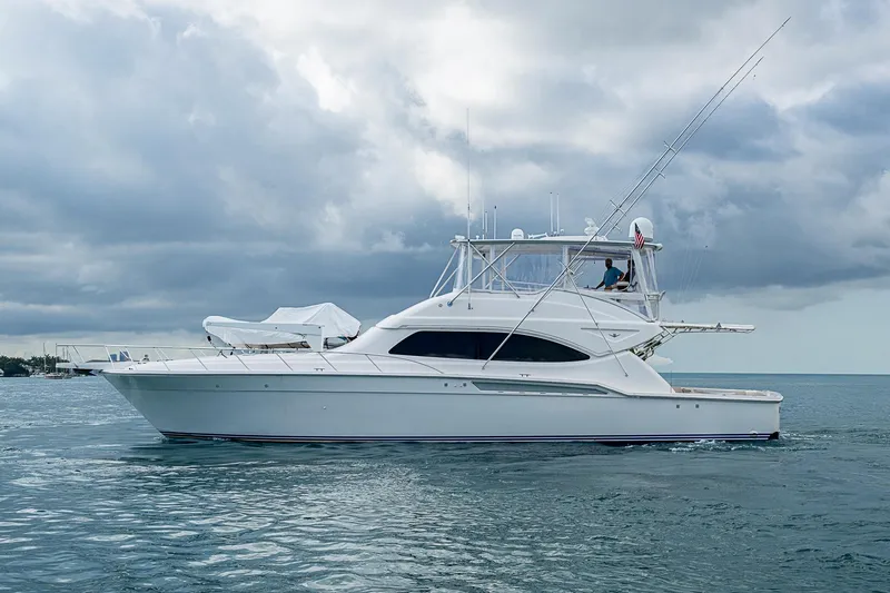 Slide: The Image of 2006 Bertram 630 Convertible yacht on calm ocean under cloudy sky. - 6