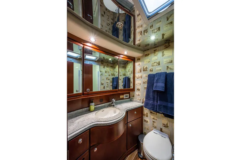 Slide: The Image of Luxurious bathroom in 2006 Bertram 630 Convertible yacht with elegant wood cabinetry and modern fixtures. - 61