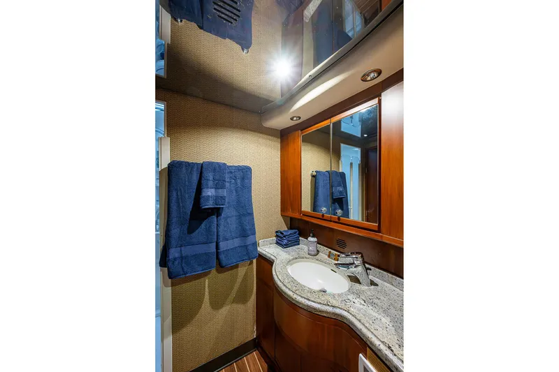 Slide: The Image of Luxurious bathroom in 2006 Bertram 630 Convertible yacht with granite countertop and wooden cabinetry. - 67