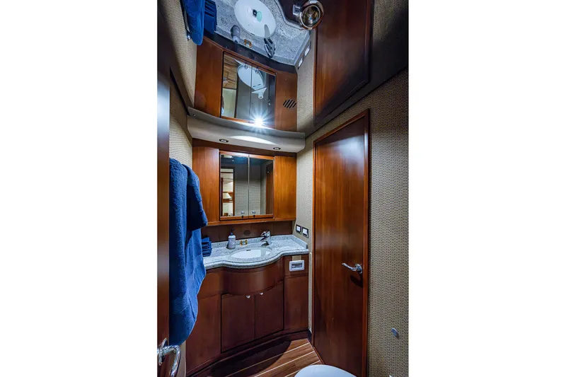 Slide: The Image of Luxurious bathroom interior of 2006 Bertram 630 Convertible yacht with wooden cabinetry and modern fixtures. - 69