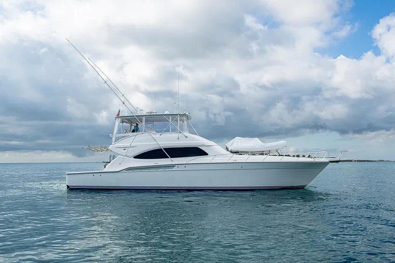 Slide: The Image of 2006 Bertram 630 Convertible yacht on calm ocean under cloudy sky. - 7