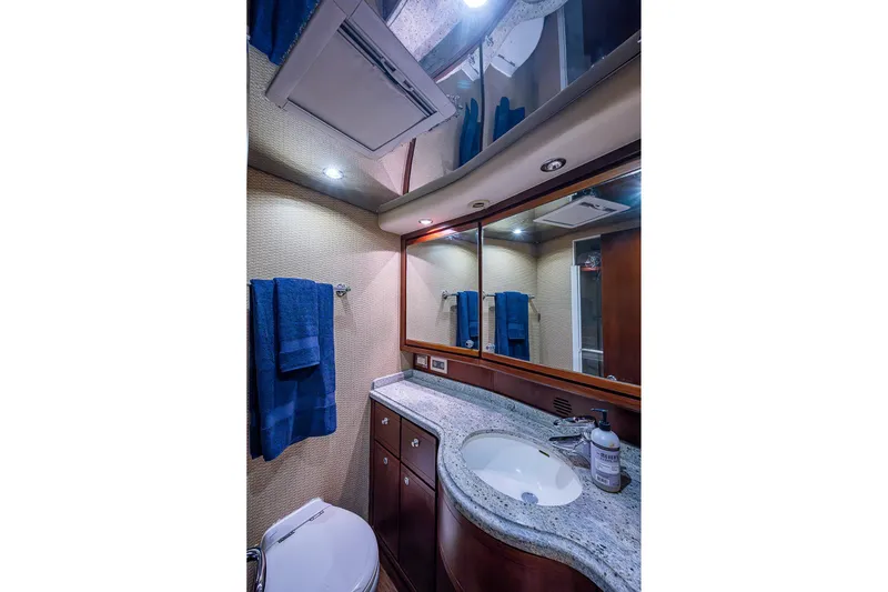 Slide: The Image of Luxurious bathroom in 2006 Bertram 630 Convertible yacht with granite countertop and elegant fixtures. - 70