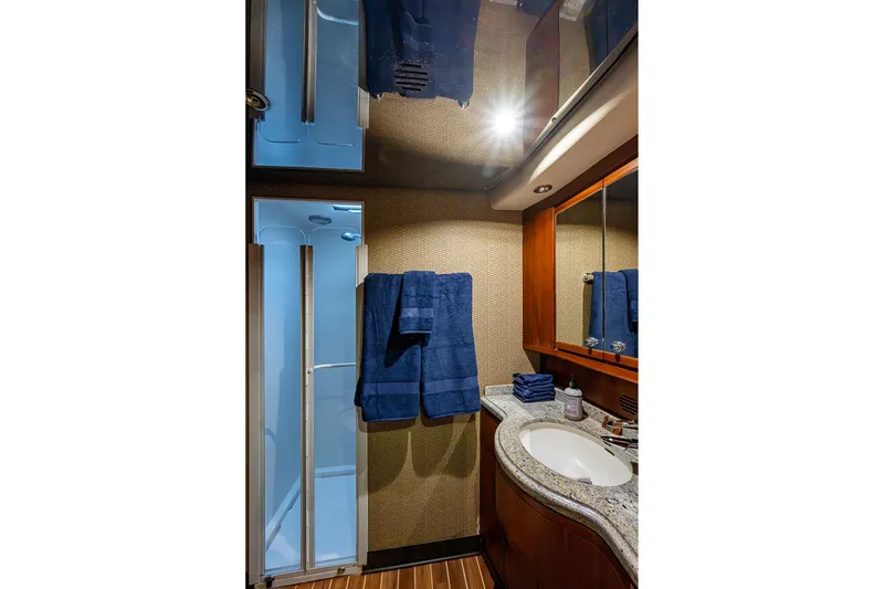 Slide: The Image of Luxurious bathroom in 2006 Bertram 630 Convertible yacht with modern fixtures and blue towels. - 71