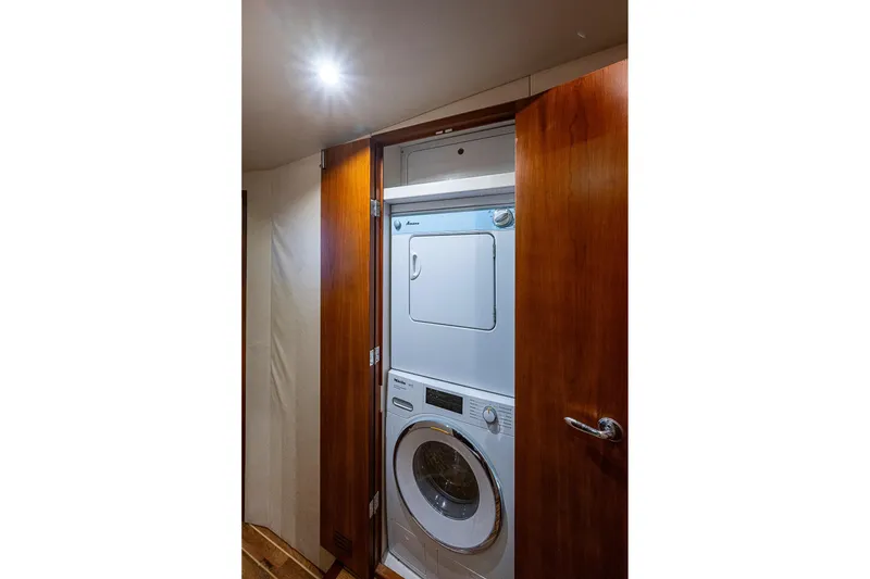 Slide: The Image of Stacked washer and dryer in 2006 Bertram 630 Convertible yacht's wooden cabinet. - 74