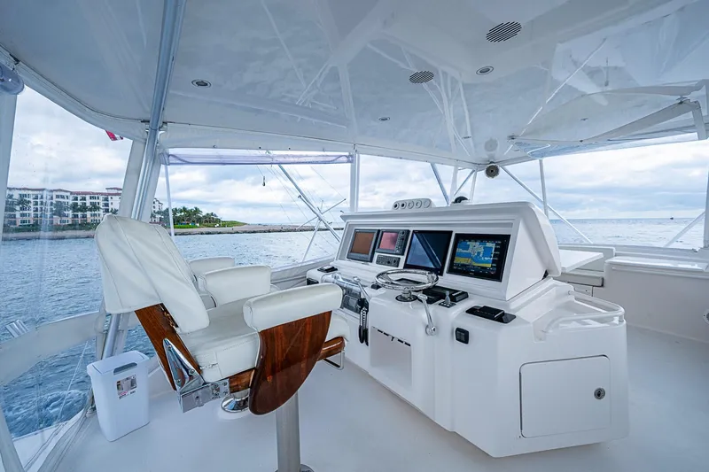 Slide: The Image of Helm of 2006 Bertram 630 Convertible yacht with modern navigation equipment and ocean view. - 75