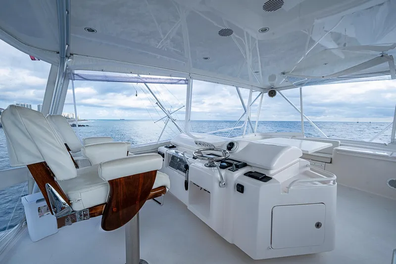 Slide: The Image of Helm of 2006 Bertram 630 Convertible yacht with ocean view and luxury seating. - 79