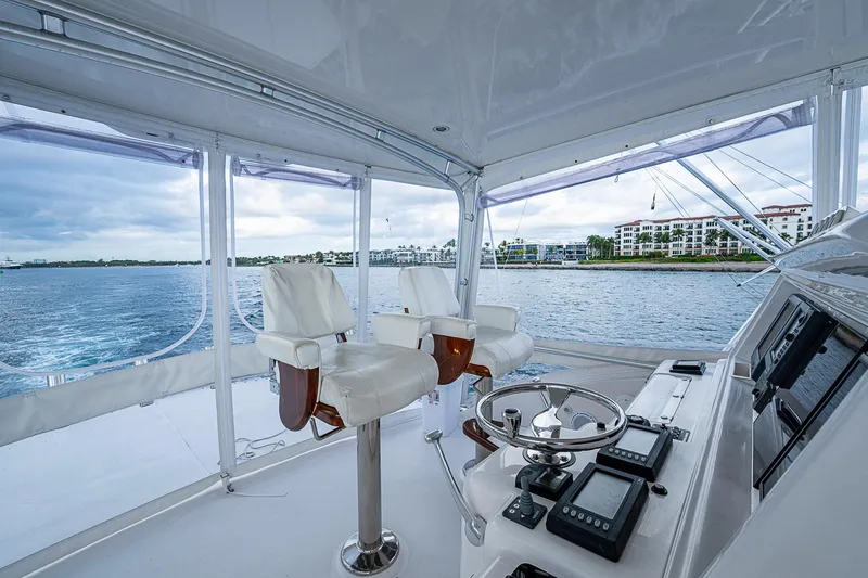Slide: The Image of 2006 Bertram 630 Convertible yacht helm with ocean view and modern controls. - 80