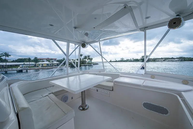 Slide: The Image of Luxurious 2006 Bertram 630 Convertible yacht interior with ocean view and seating area. - 83