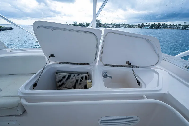 Slide: The Image of Open storage compartments on 2006 Bertram 630 Convertible yacht, with ocean view in background. - 84