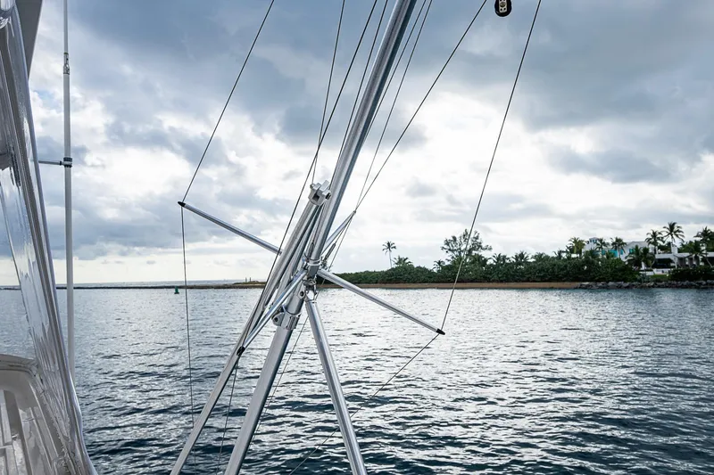 Slide: The Image of Bertram 630 Convertible yacht view with cloudy sky and coastal scenery, 2006 model. - 85