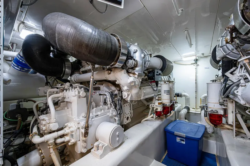 Slide: The Image of Engine room of 2006 Bertram 630 Convertible yacht, showcasing dual engines and mechanical components. - 88
