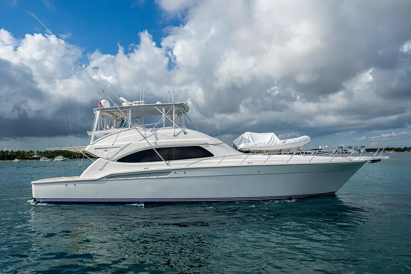 Slide: The Image of 2006 Bertram 630 Convertible yacht on calm water under cloudy sky. - 9