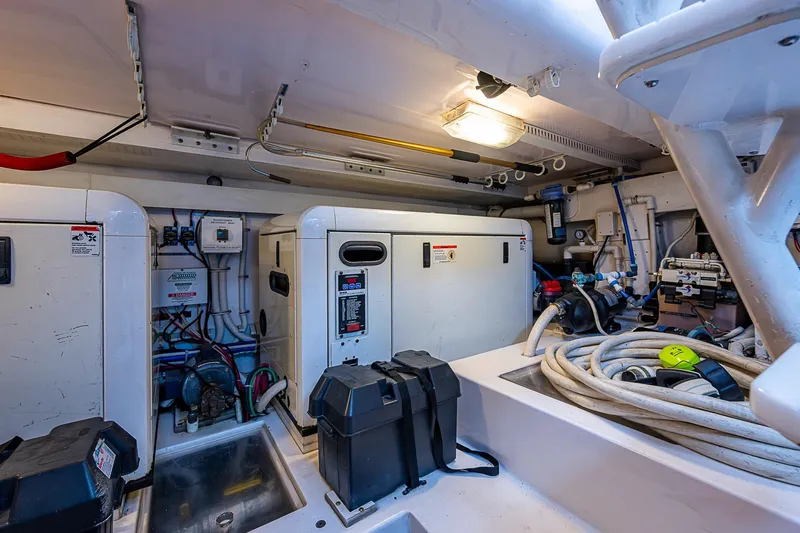 Slide: The Image of Engine room of 2006 Bertram 630 Convertible yacht with equipment and cables. - 90