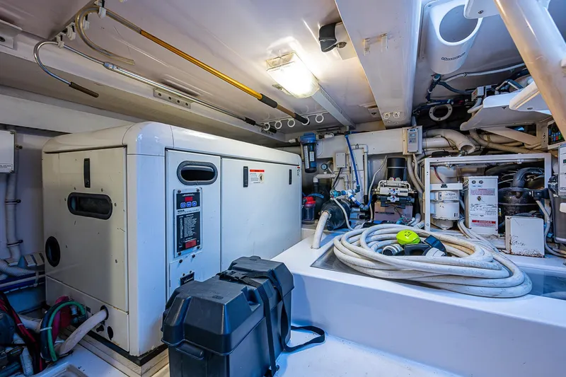Slide: The Image of Engine room of 2006 Bertram 630 Convertible yacht, featuring equipment and wiring. - 92