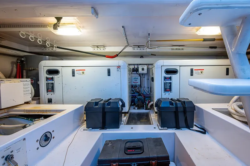 Slide: The Image of Engine room of a 2006 Bertram 630 Convertible yacht, featuring equipment and storage. - 94