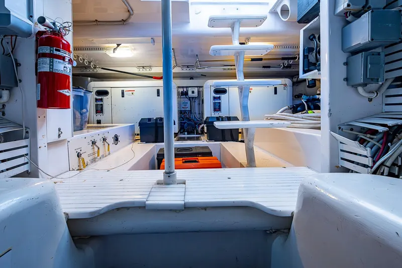 Slide: The Image of Engine room of 2006 Bertram 630 Convertible yacht, featuring equipment and safety gear. - 95