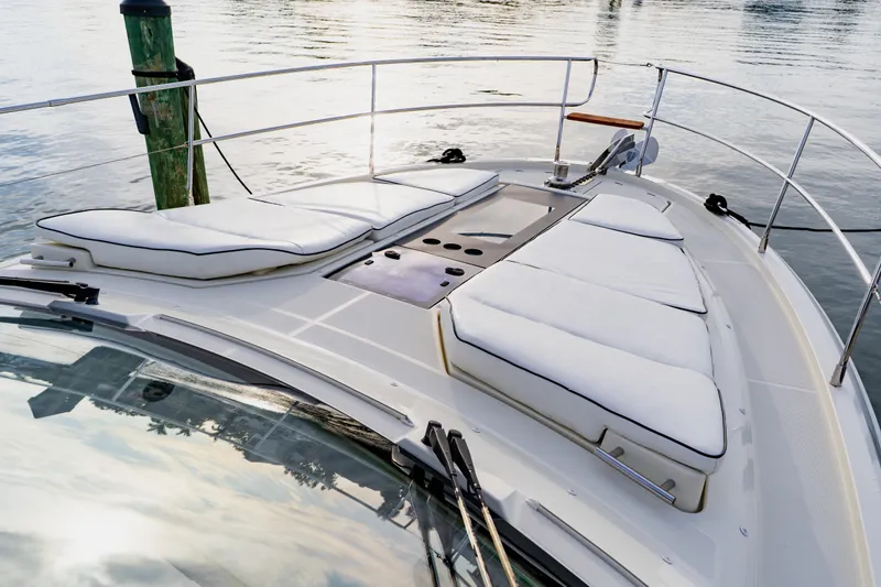 Slide: The Image of Luxurious 2015 Monte Carlo MC5 yacht with cushioned deck, docked by calm waters. - 11