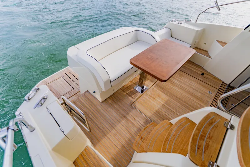 Slide: The Image of Luxurious 2015 Monte Carlo MC5 yacht deck with seating and wooden table. - 14