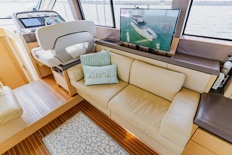 Slide: The Image of Luxurious Monte Carlo MC5 yacht interior with leather seating, TV, and nautical decor. - 19