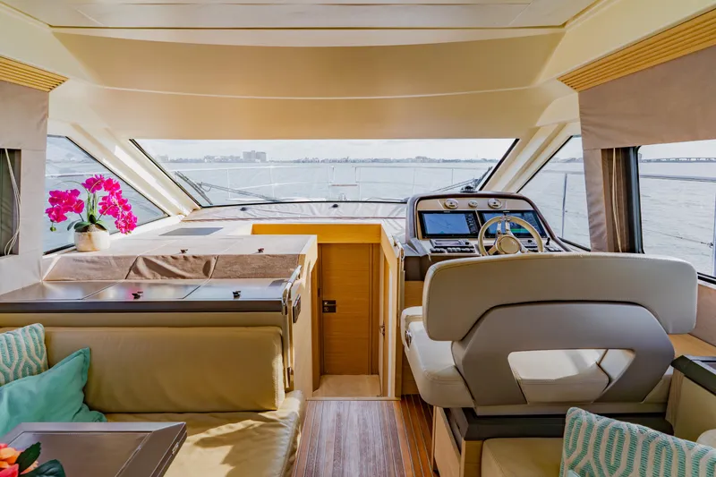 Slide: The Image of Luxurious 2015 Monte Carlo MC5 yacht interior with helm, seating, and vibrant pink flowers. - 23