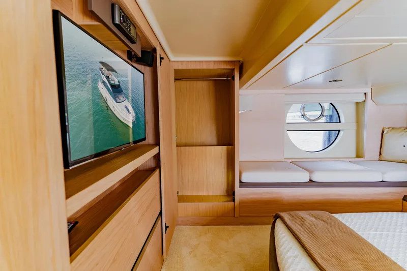 Slide: The Image of Luxurious Monte Carlo MC5 2015 yacht interior with TV, bed, and porthole window. - 34
