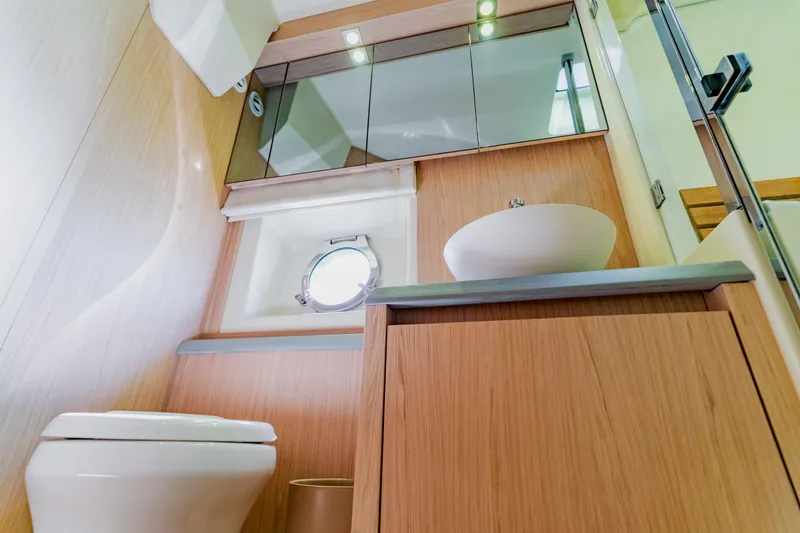 Slide: The Image of Luxurious bathroom in 2015 Monte Carlo MC5 yacht with modern fixtures and wooden cabinetry. - 37